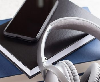 audiobook concept modern wireless headphones smartphone and book